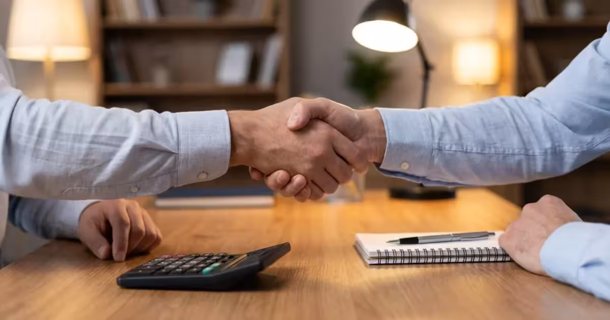 A happy family laughing together on a sunny porch, representing financial security and peace of mind.