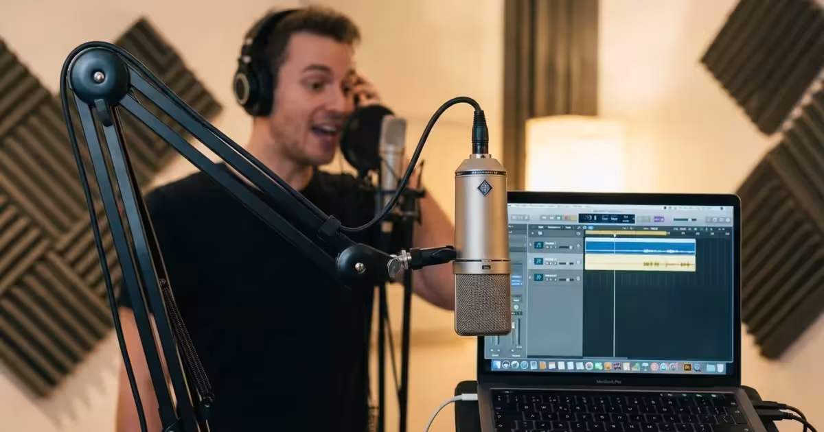 A woman recording voiceover in a sunlit, professional home studio.